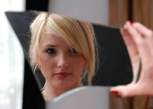 Lady looking at herself in mirror